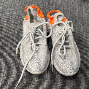 White and Orange Low-Top Sneakers with Modern Design